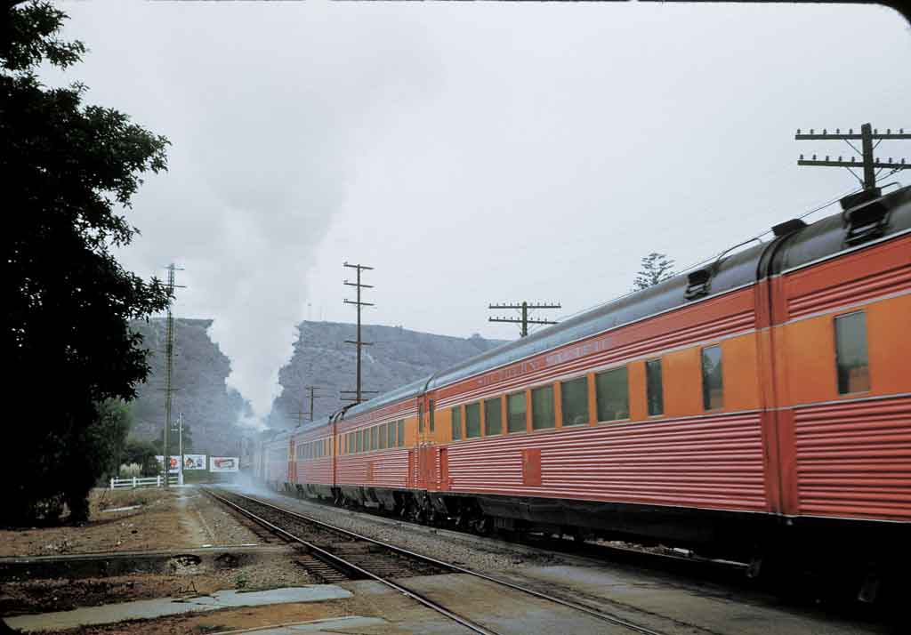 A close up picture of an orange train passing by