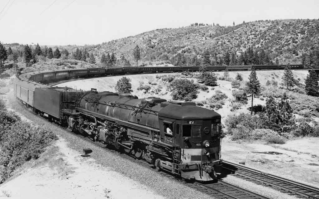 A black and white photo of a locomotive turning a corner