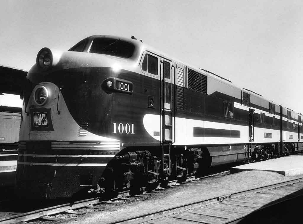 A black and white photo of a close up of a locomotive sitting on the tracks