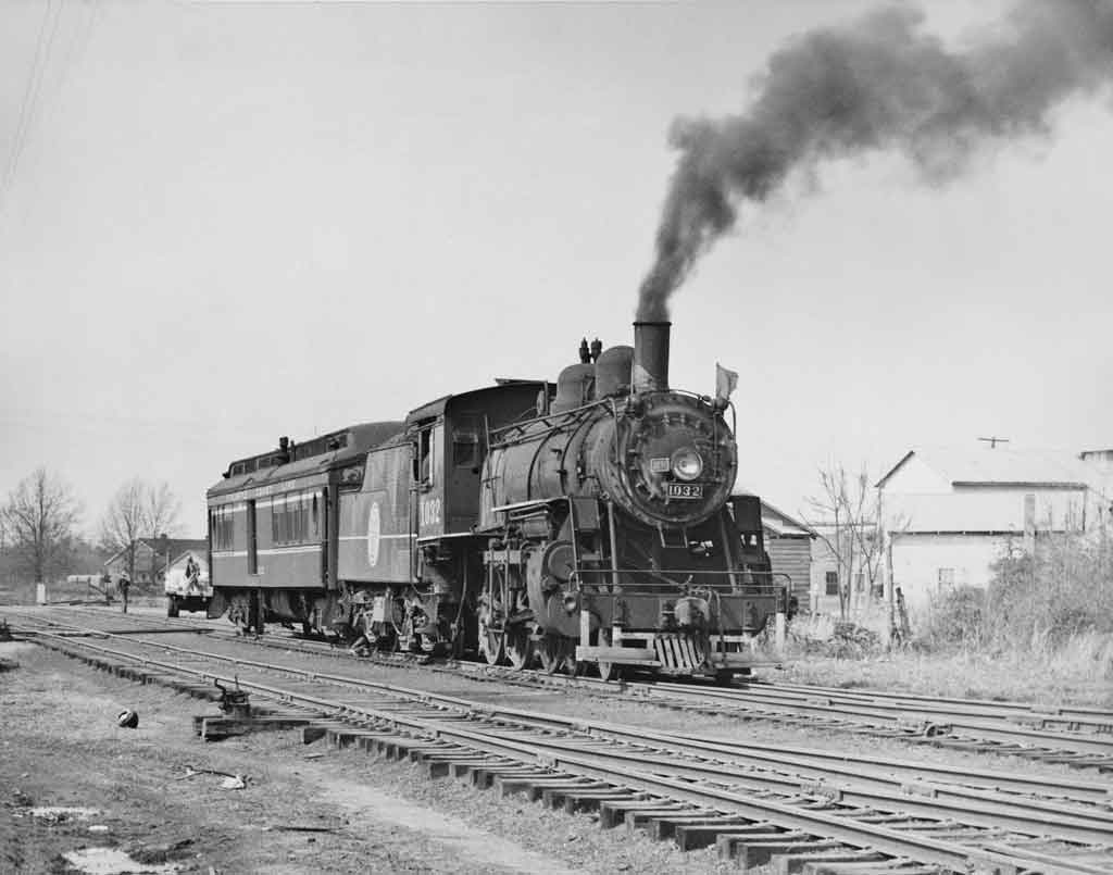 a steam engine pulling a passenger car