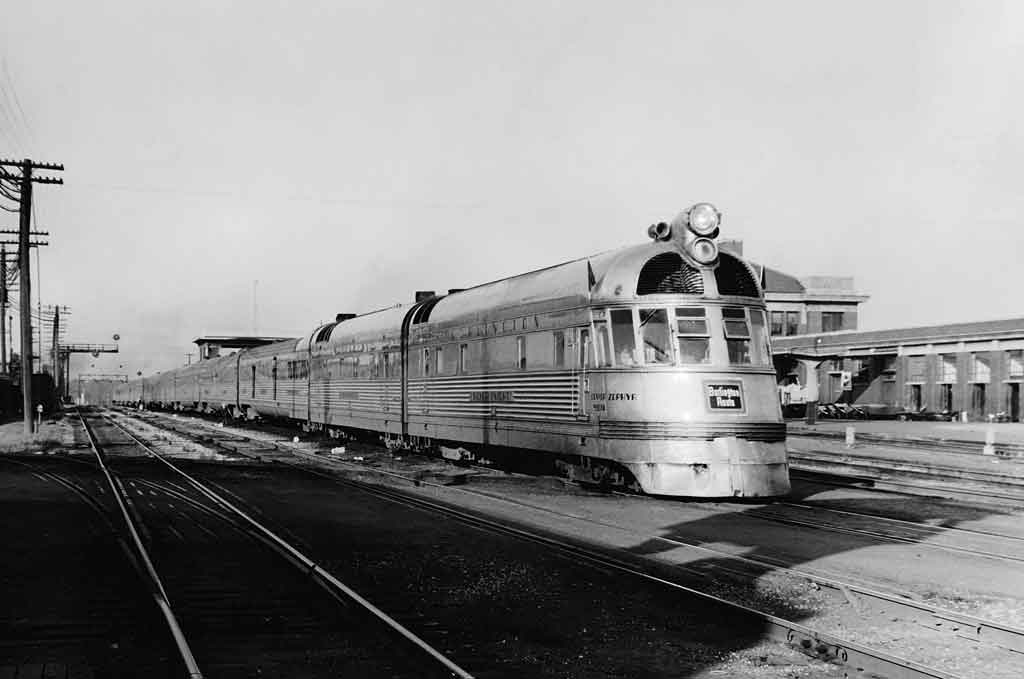 A black and white photo of a train sitting at a station