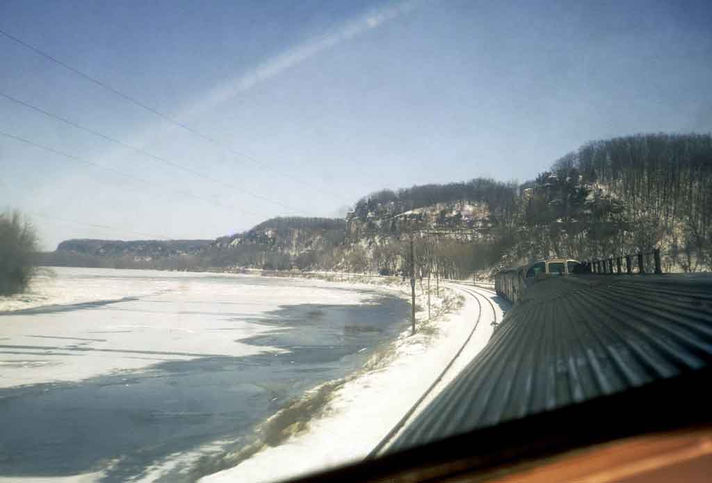 A photo taken from the top of a train as it travels through a snowy area