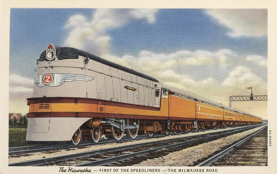 A postcard with a orange and white locomotive on it
