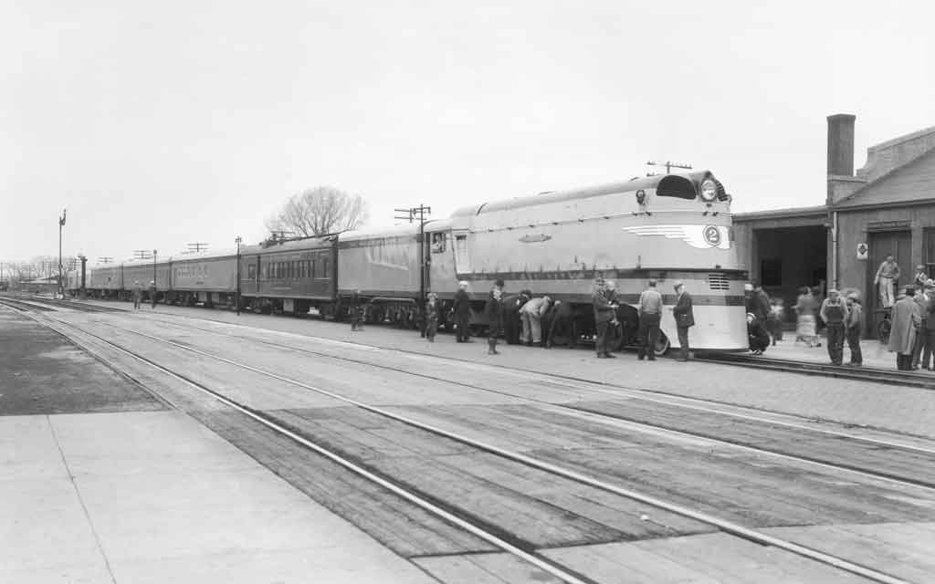 A black and white photo of people boarding a train