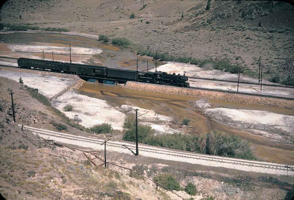 An overhead distance shot of a locomotive on the tracks