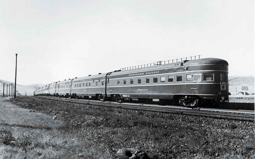 A black and white photo of a locomotive on the tracks