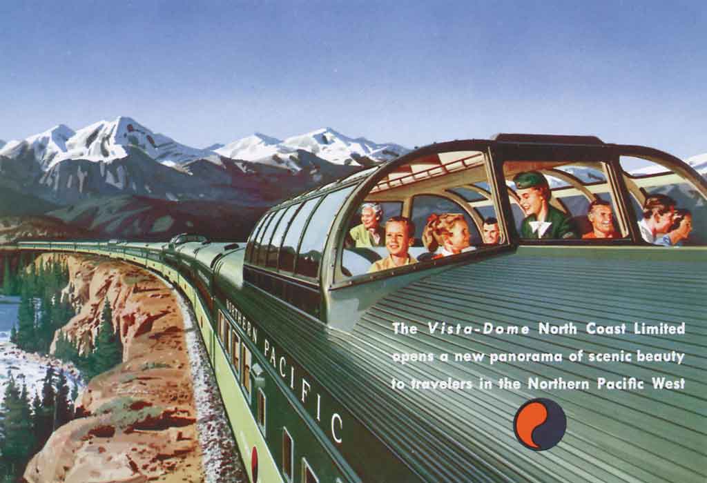 A postcard that shows passengers sitting inside a green train as it passes through the mountains