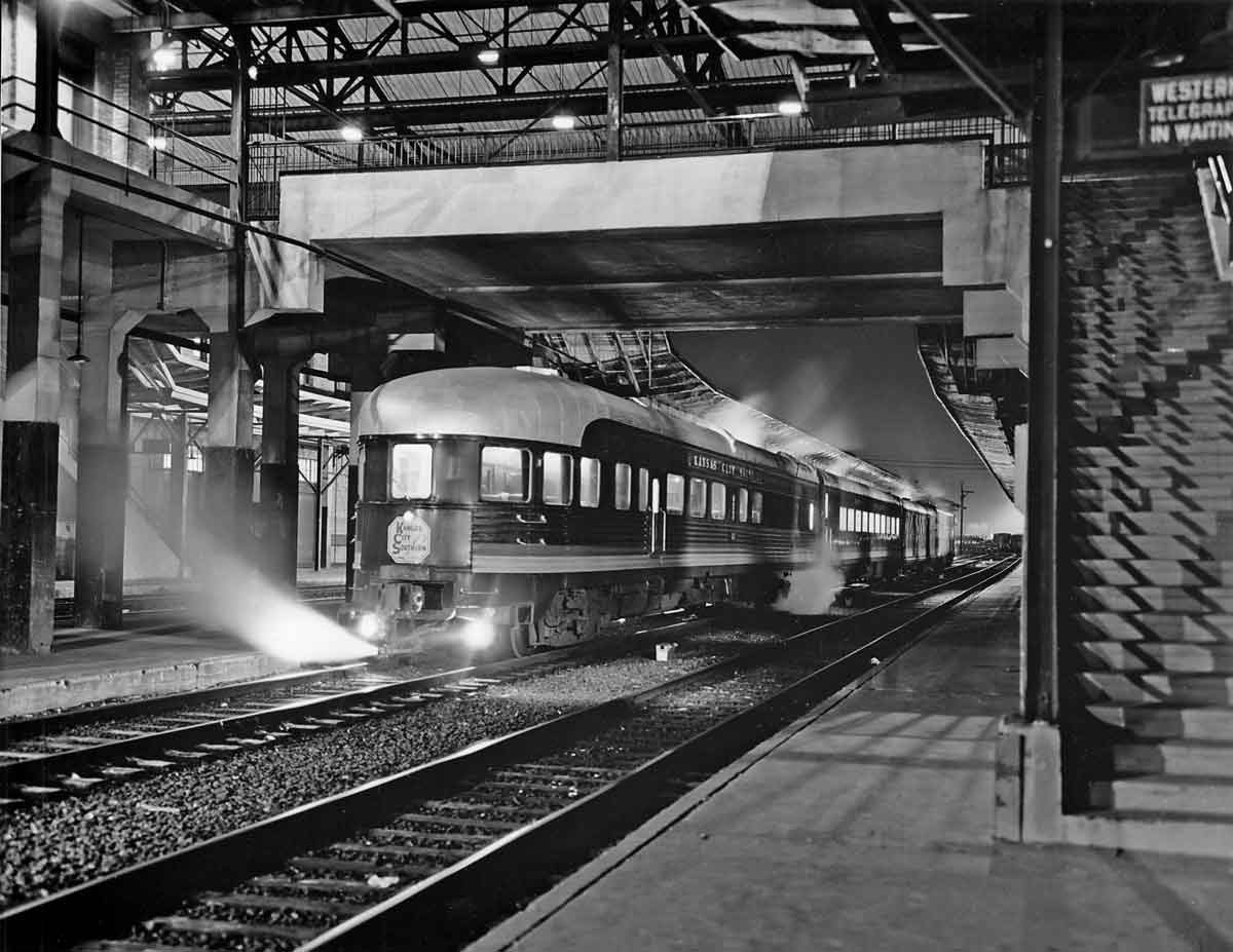 End of streamlined passenger car in station at night