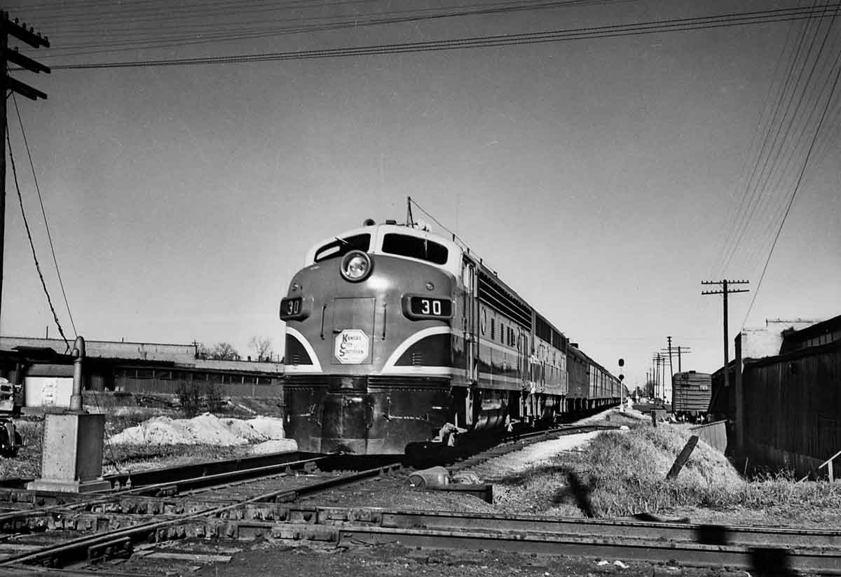 Diesel locomotives with passenger train approaching diamond crossing