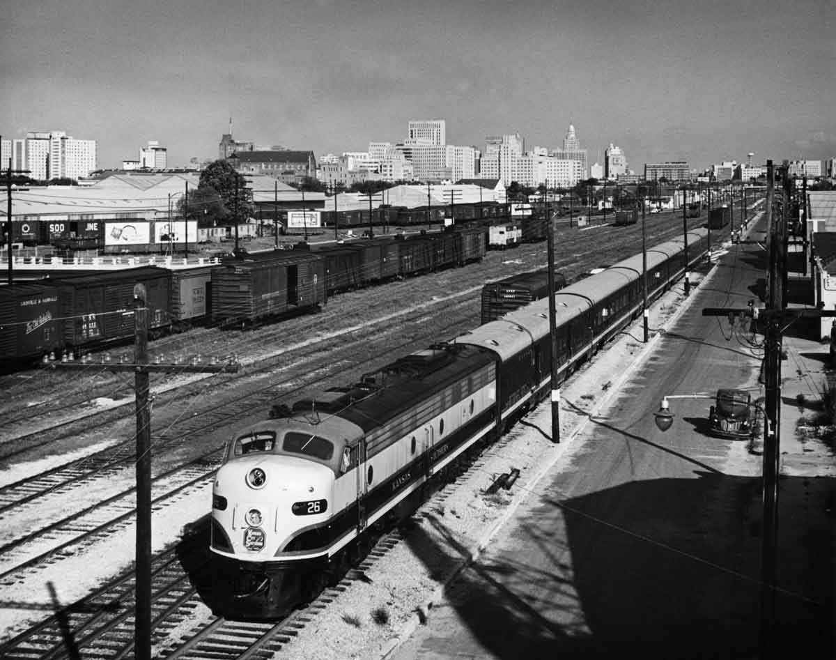 Diesel locomotive with passenger train in freight yard