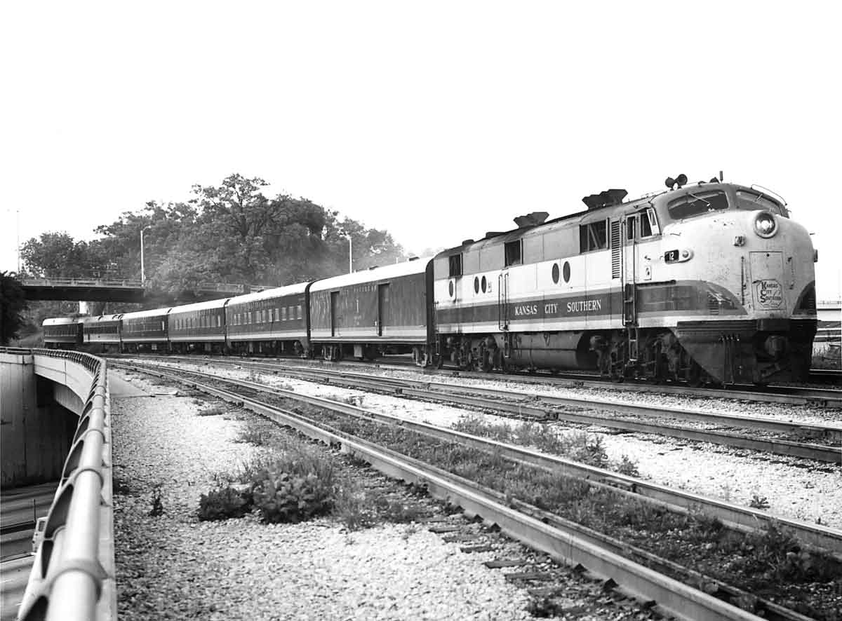 Diesel locomotive with six-car passenger train on curve