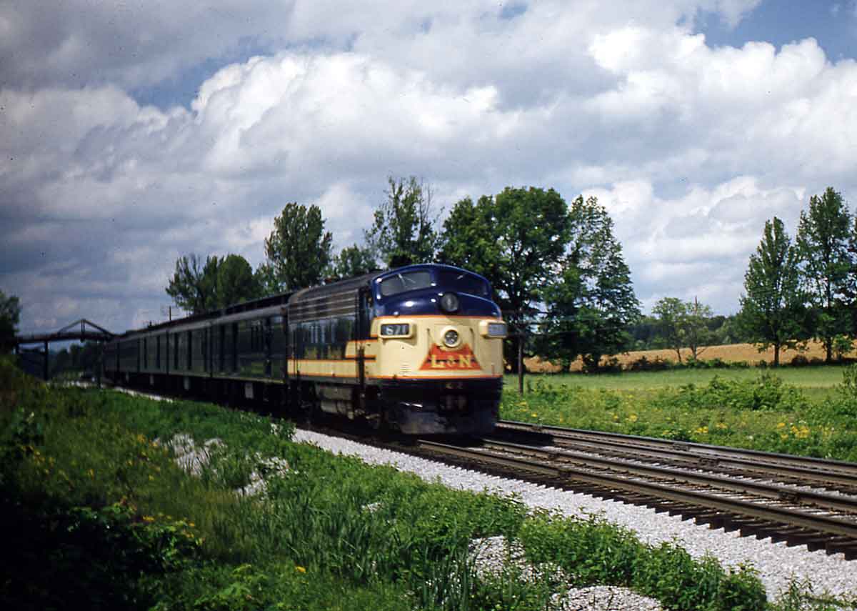 A yellow and navy blue passing through a rural area