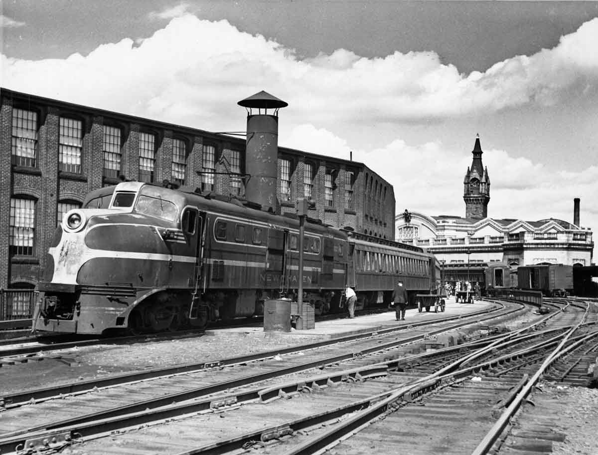 a diesel passenger train at a train station