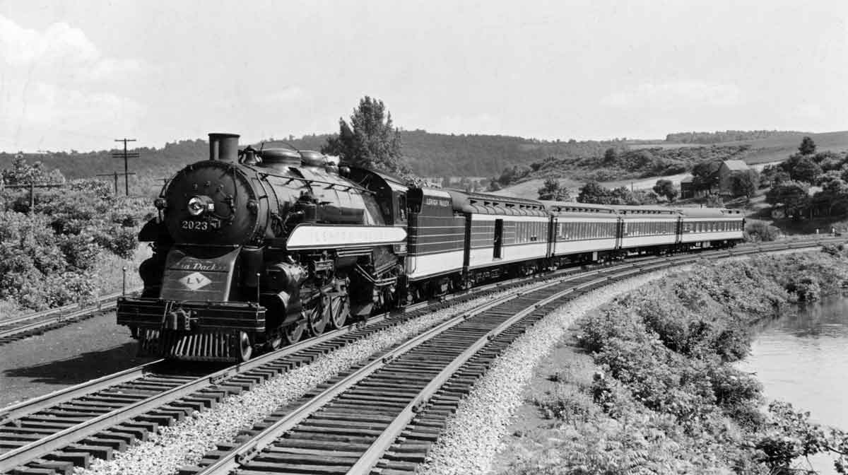 A black and white photo of a locomotive turning a corner