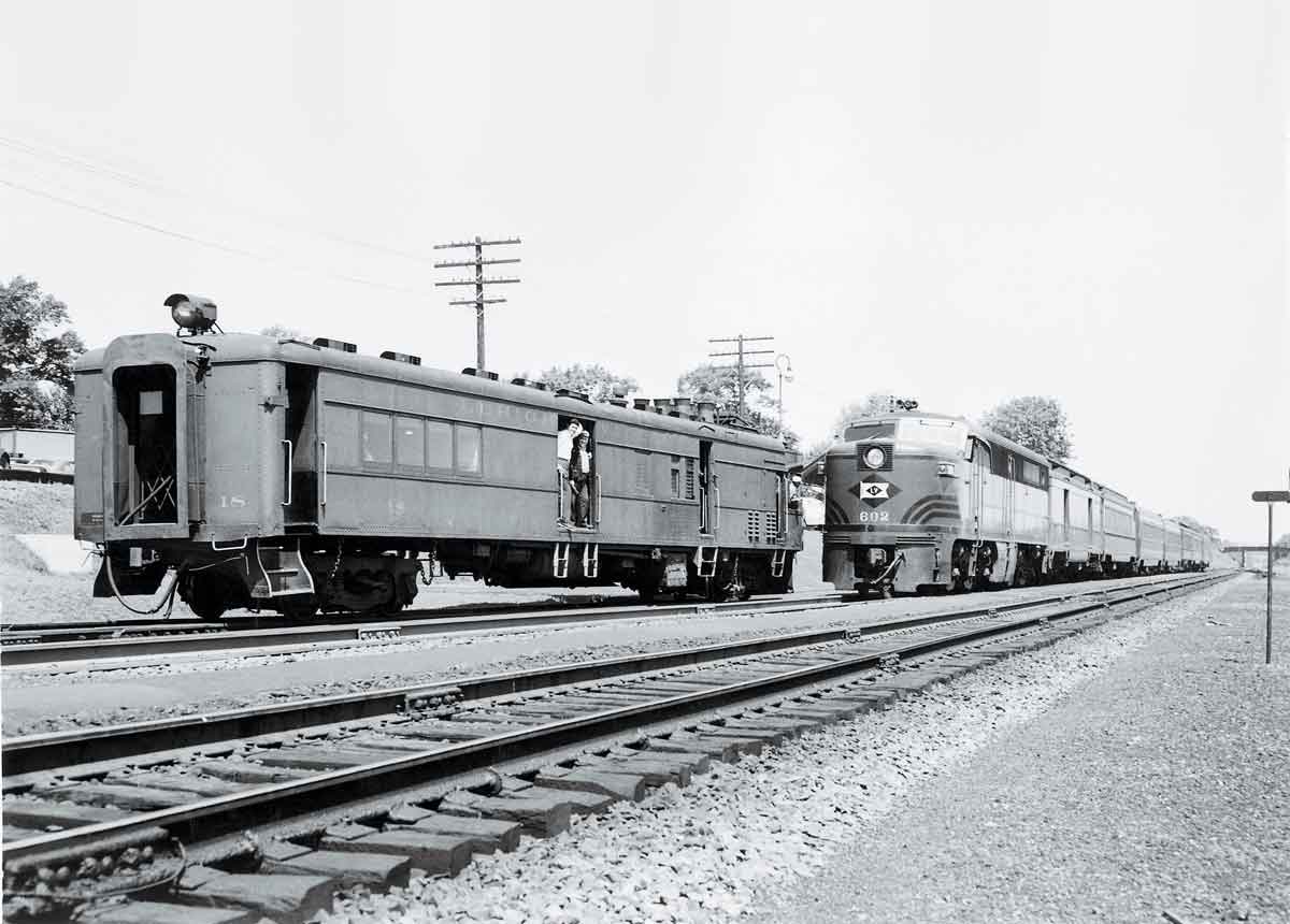 A black and white photo of two trains passing each other