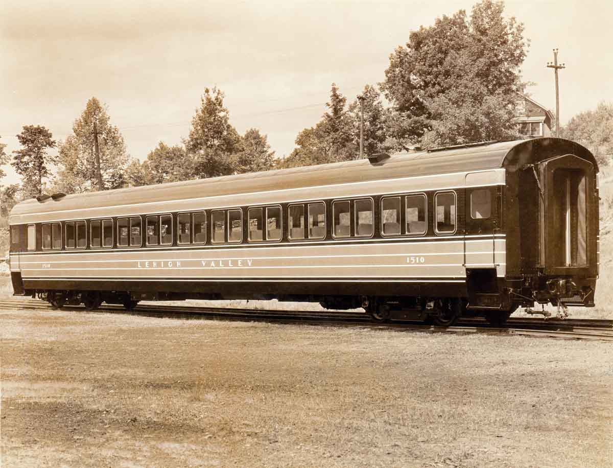 A photo of a passenger car sitting on the tracks