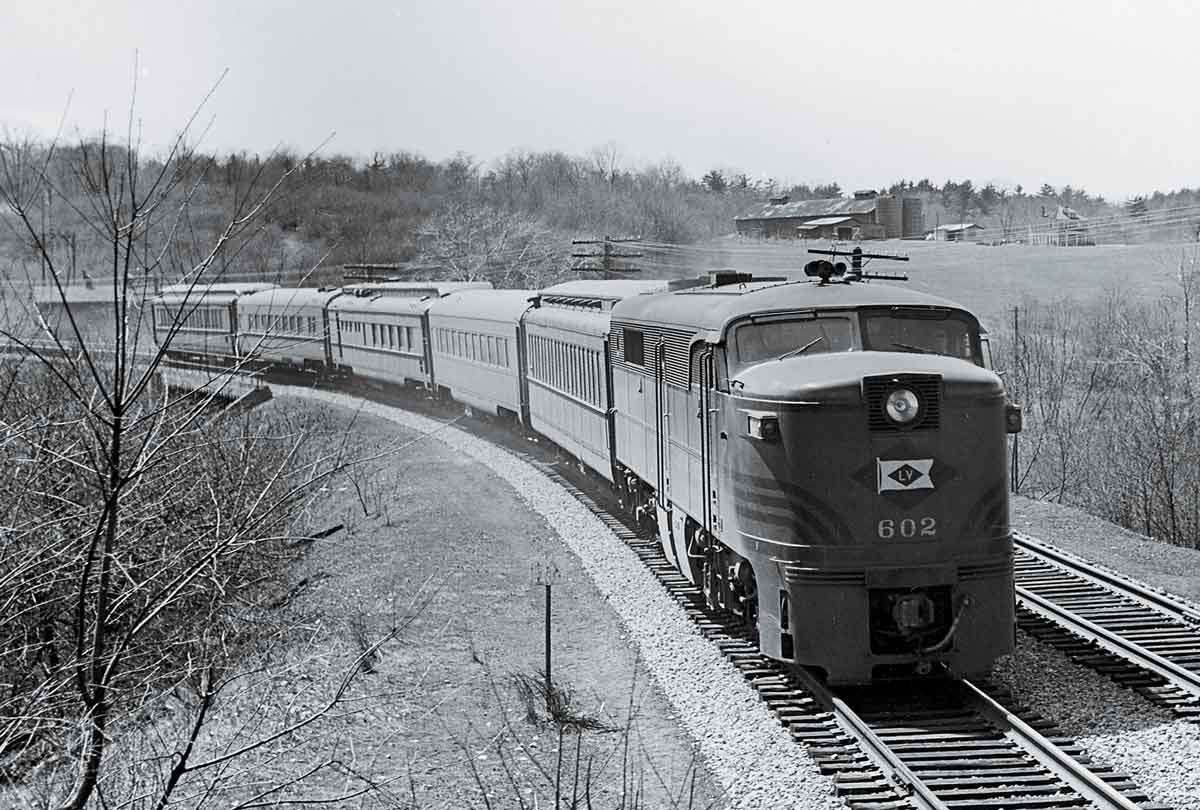 A black and white photo of a locomotive turning a corner