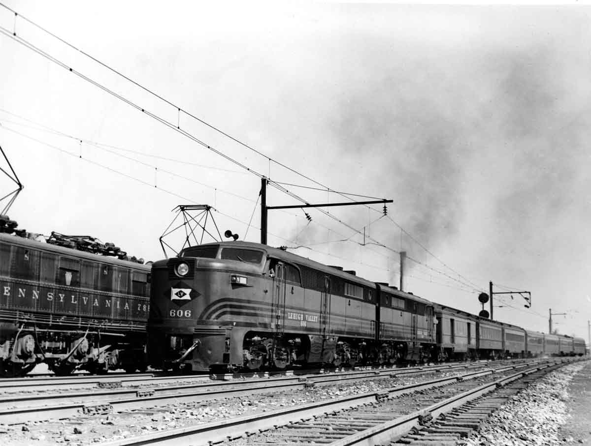 A black and white photo of two trains side by side on the tracks