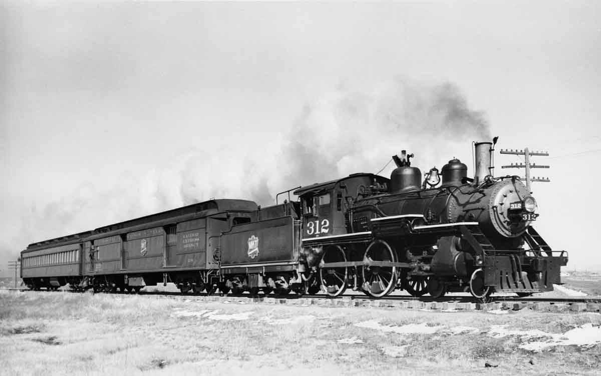 A steam engine pulling passenger cars