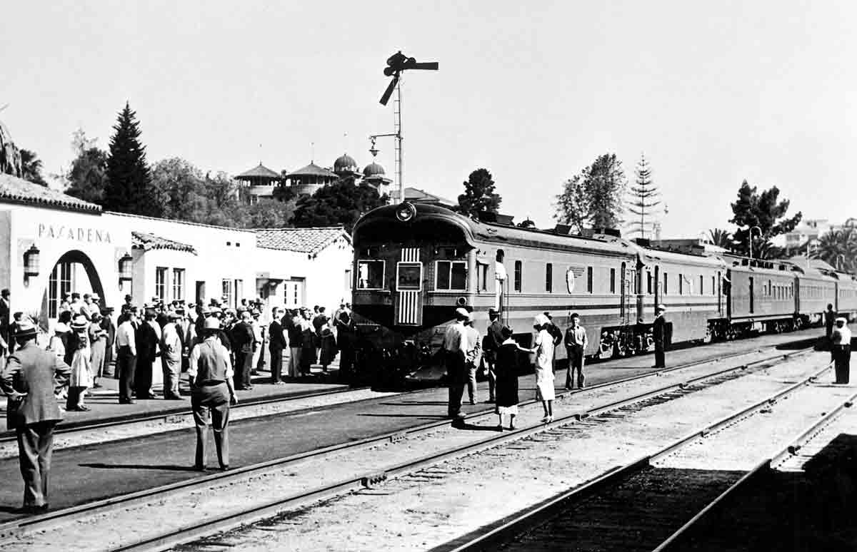 Passengers standing around a passenger train