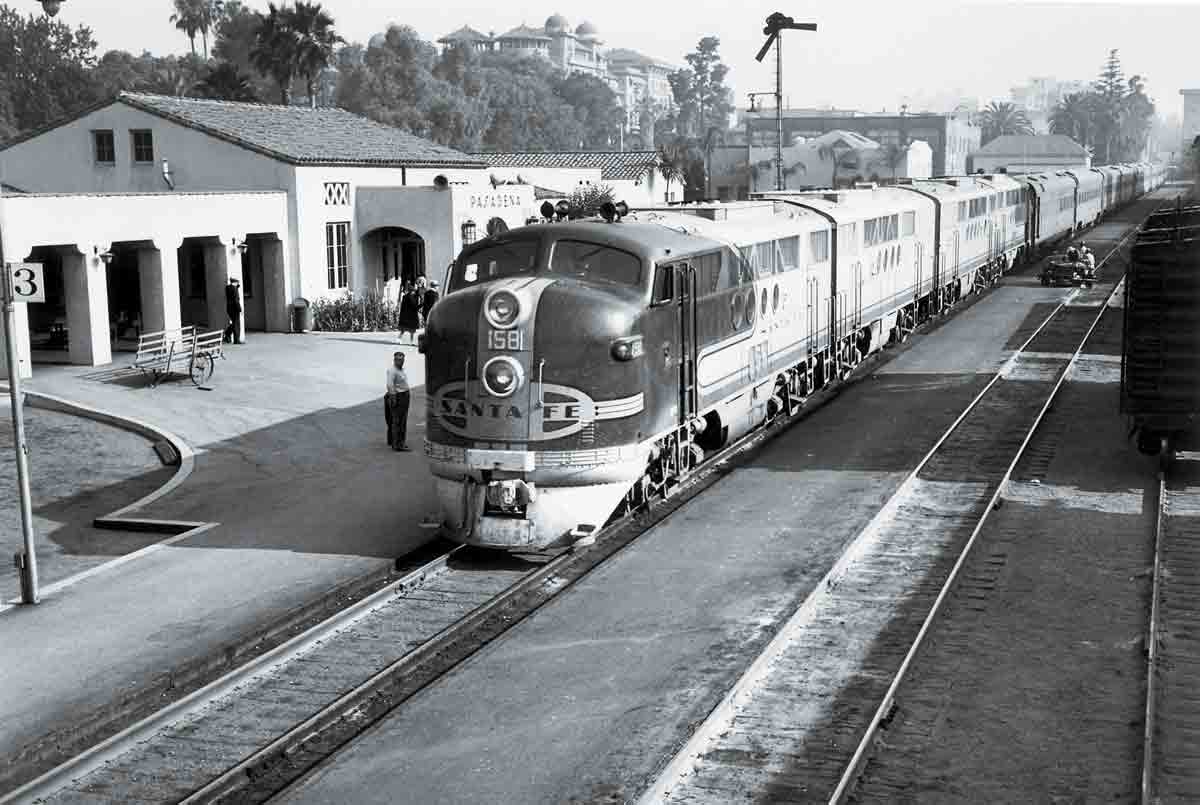 A passenger train sitting at the station waiting for passengers