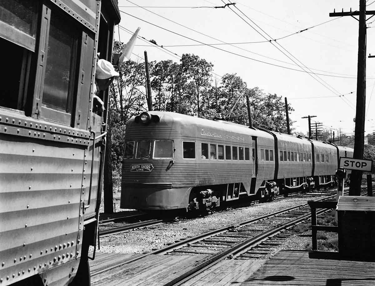 A passenger train passing a standard car