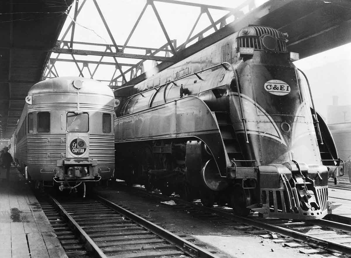 a passenger car next to a streamliner