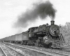 a steam engine pulling passenger cars