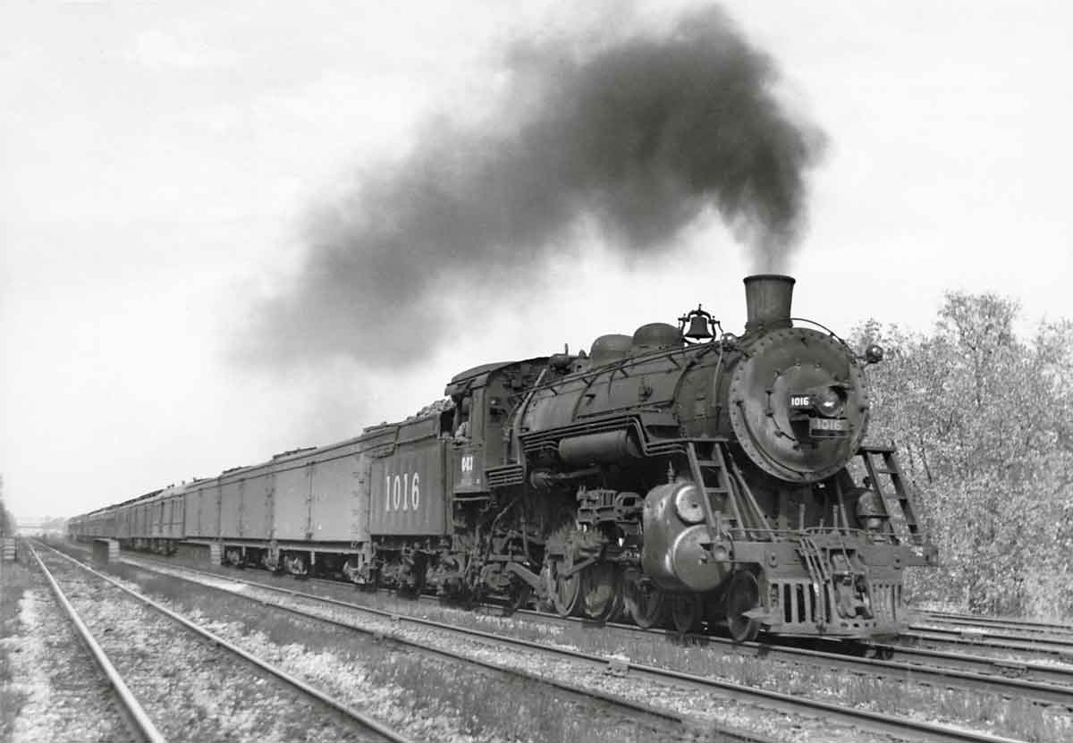 a steam engine pulling passenger cars