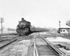 a steam engine pulling passenger cars
