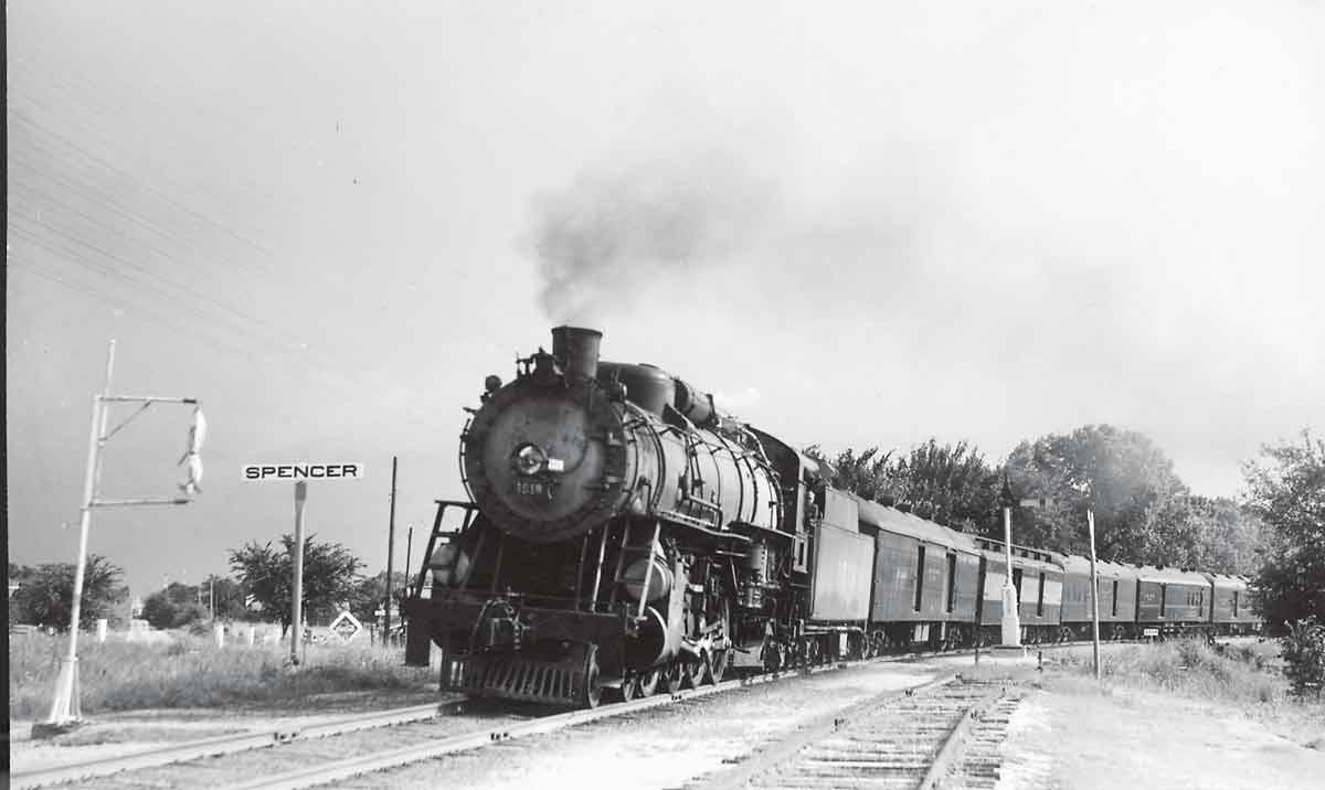 a steam engine pulling box cars