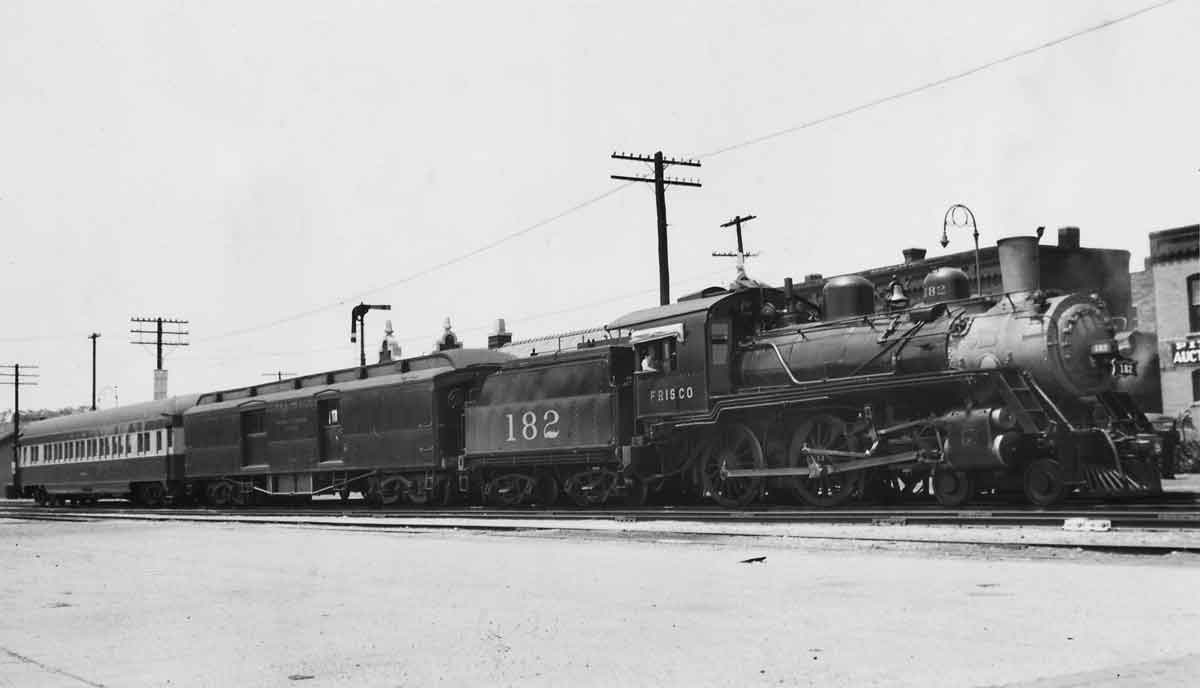a steam engine pulling passenger cars