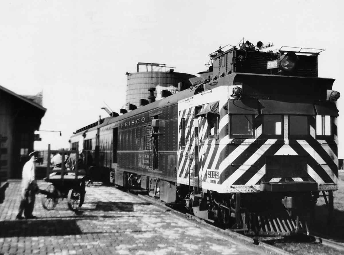 Passengers at a station loading a passenger train