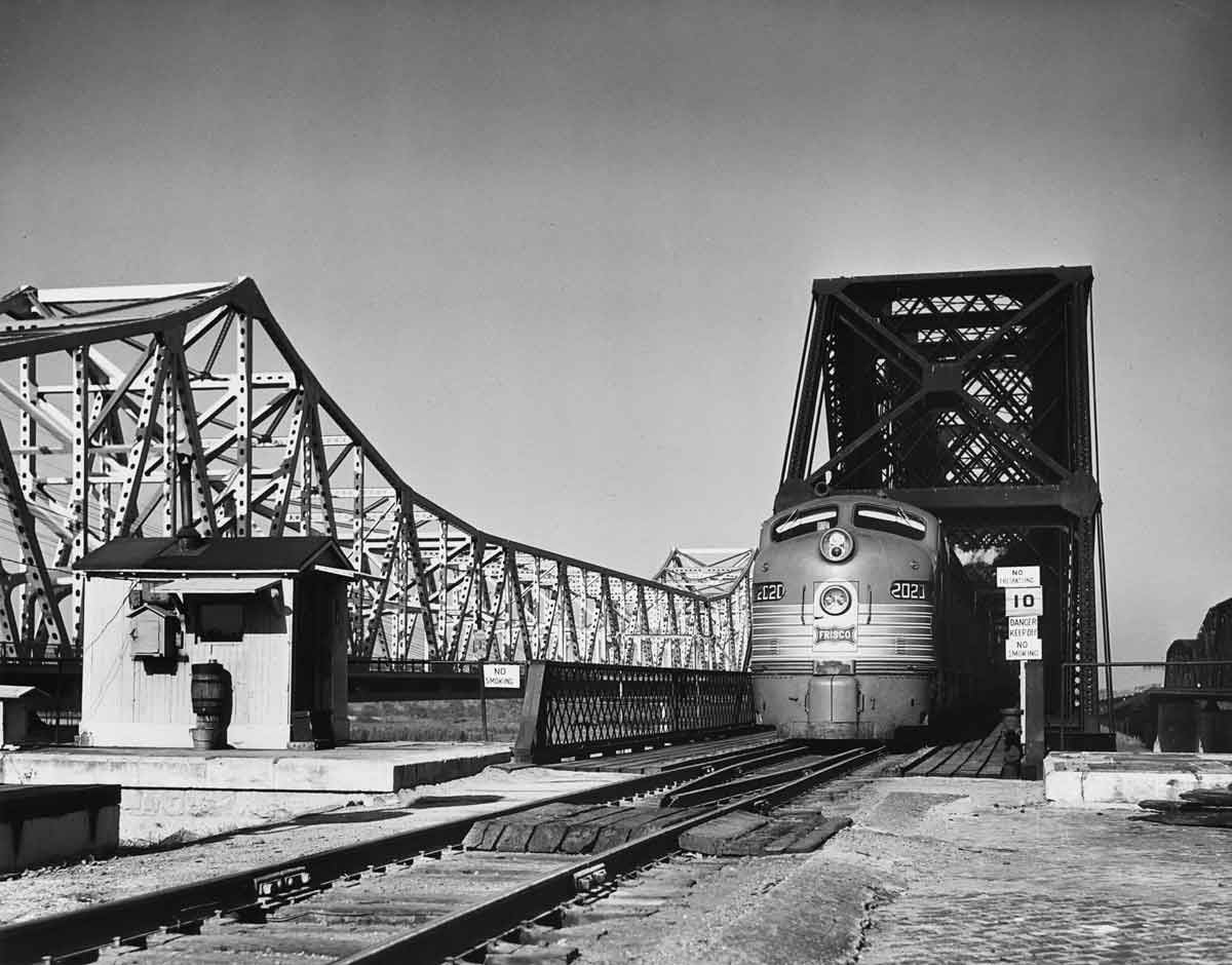 a passenger train crossing a large bridge