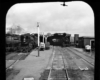 three trains by a building