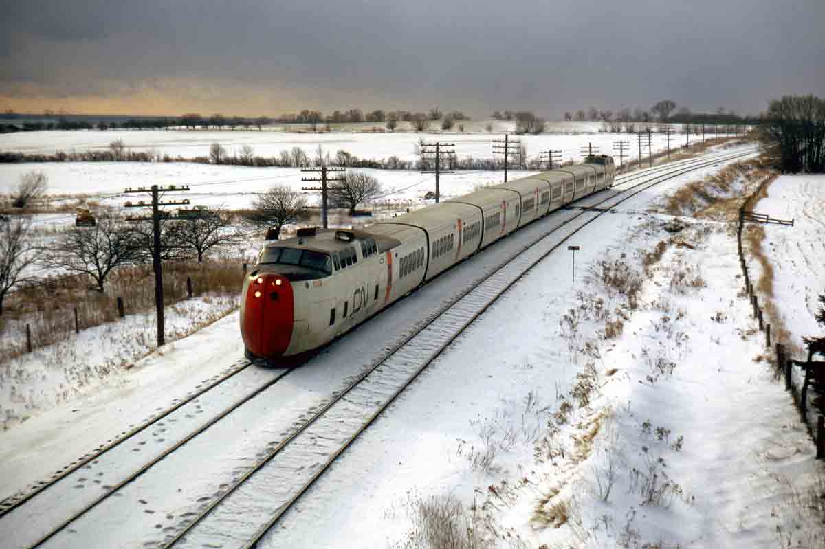 a passenger train on a snowy landscape