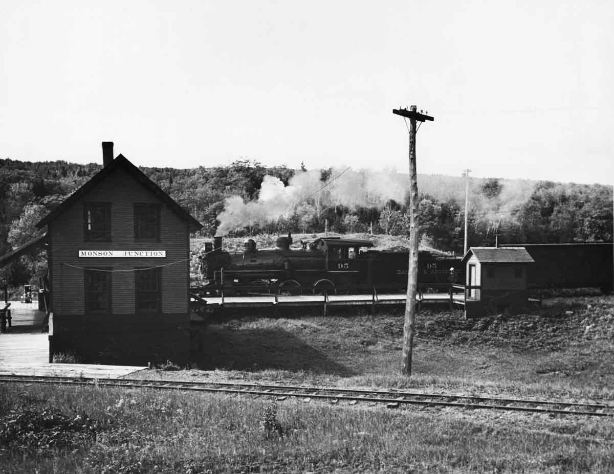 a steam passenger train pulling into a depot