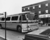 a bus in a street with a hotel in the background