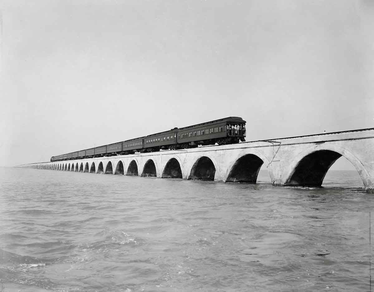 a passenger train on a viaduct over water