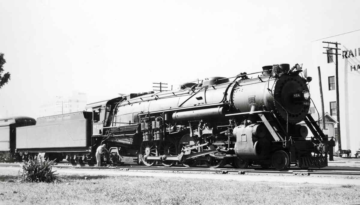 a steam engine with passenger cars
