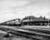 a diesel passenger train by a passengerstation