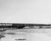 a train on a small bridge over water