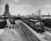 five passenger trains grouped together in a yard