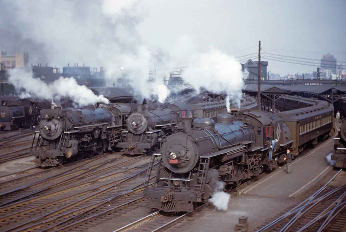 A handful of trains parked outside a rail yard