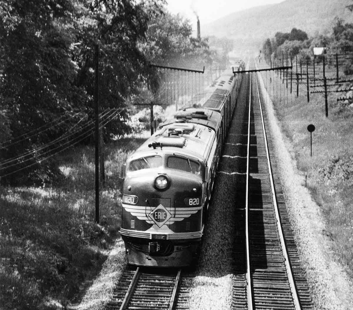 A black and white overhead shot of a train passing by