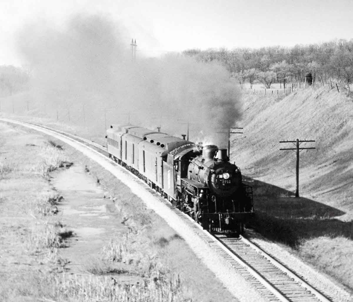a steam engine pulling cars