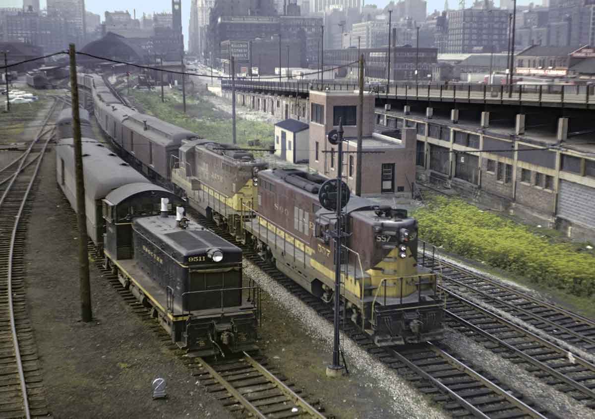 a couple of trains side by side with Chicago in the background