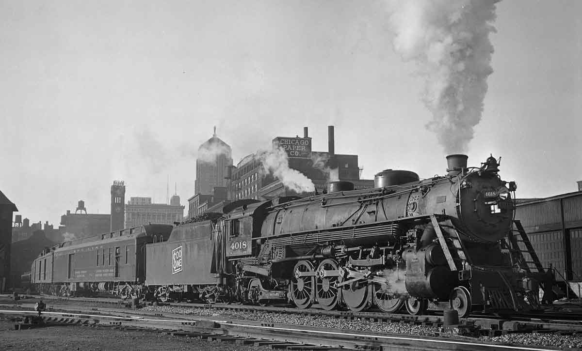 a steam engine and passenger cars departing Grand Central Station and Chicago in the background