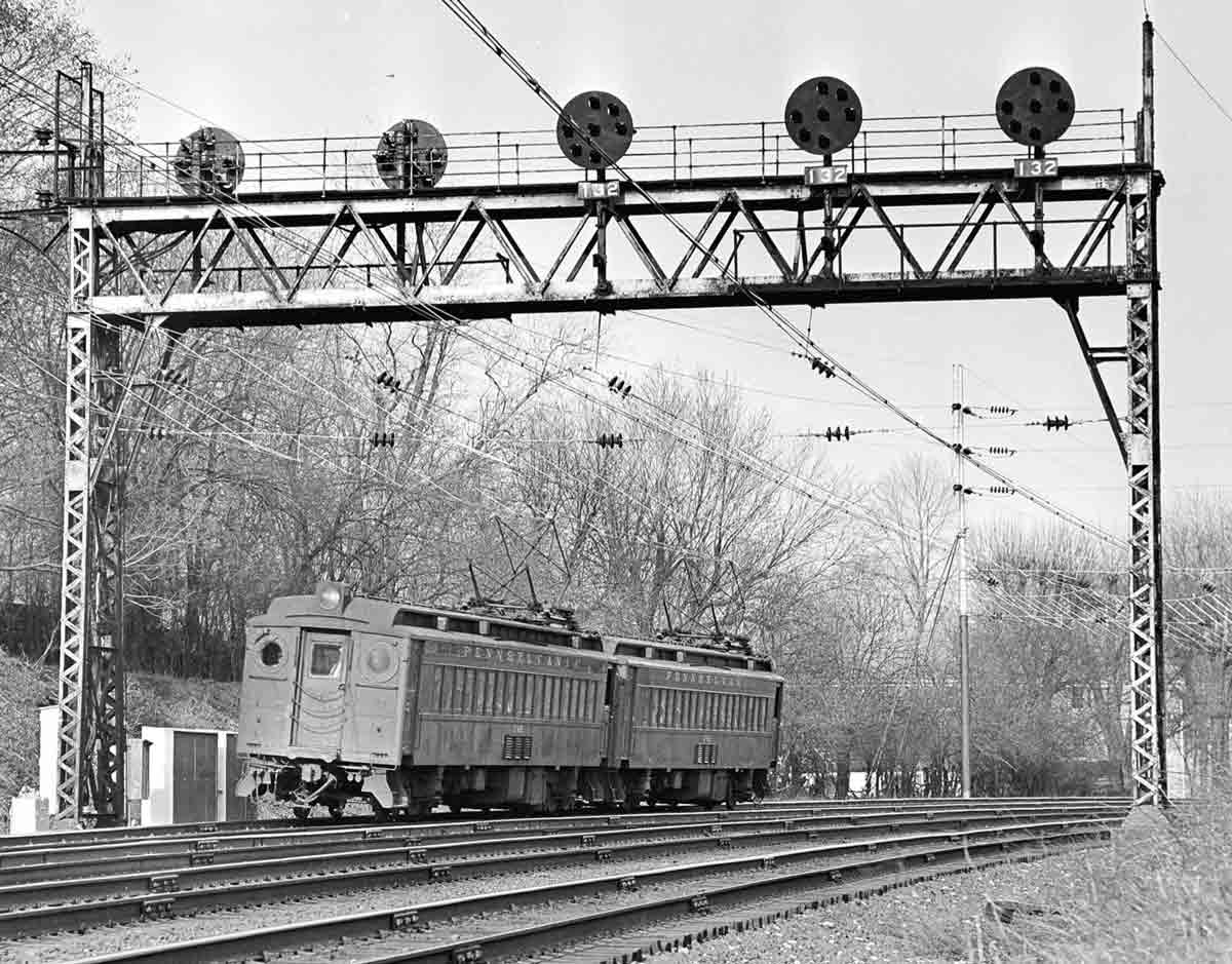 A train passing below a stop light