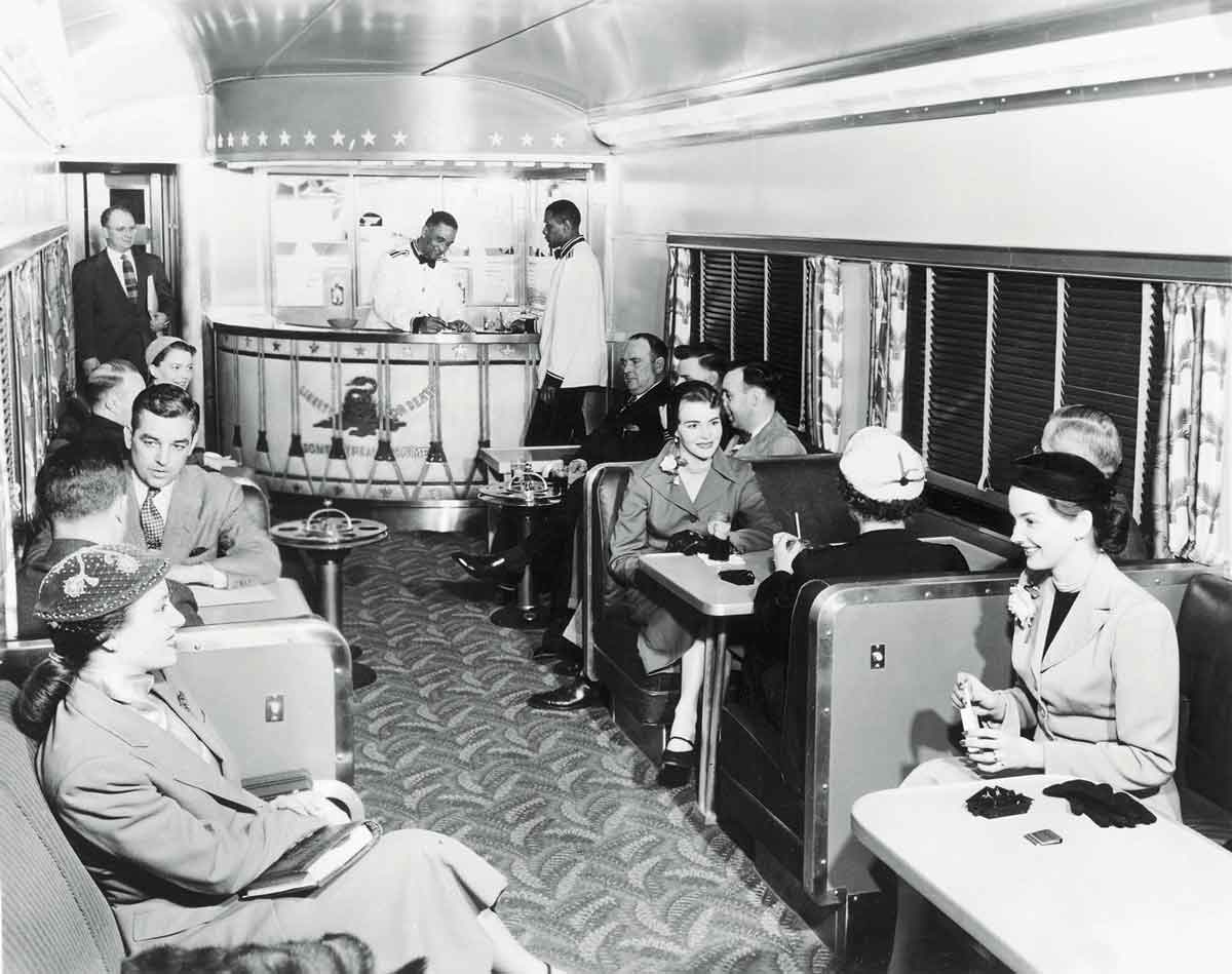 People sitting and talking inside a train